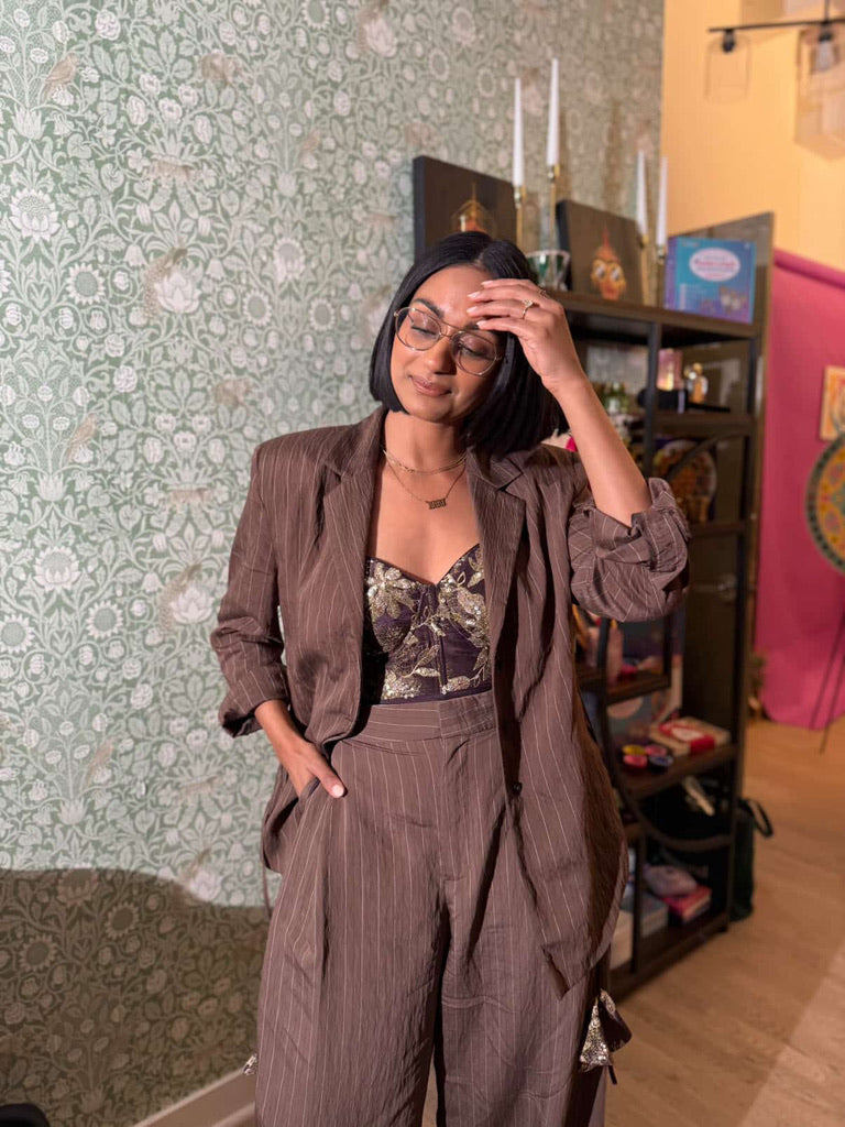 Shanelle Kaul, CBS News correspondent, wearing a Dee Kapadiya Ahilya Corset styled with a blazer — a modern fusion of heritage and contemporary power dressing.