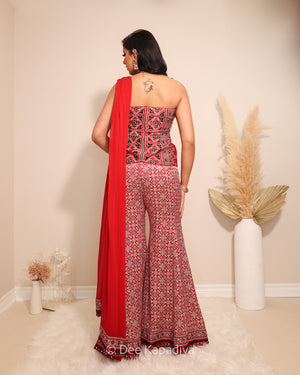 Dee Kapadiya Bahaar Gharara Set in Mirchi Red — back view showing halter neck Mastani top and Bahaar gharara hem with ajrakh embroidered border and mirror work, mehndi sangeet outfit Toronto