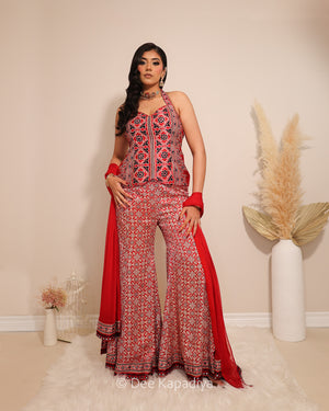 Dee Kapadiya Bahaar Gharara Set in Mirchi Red — Mastani halter top and wide-leg gharara in geometric ajrakh print on gajji silk with real mirror work border, front view, Indian wedding guest outfit Canada