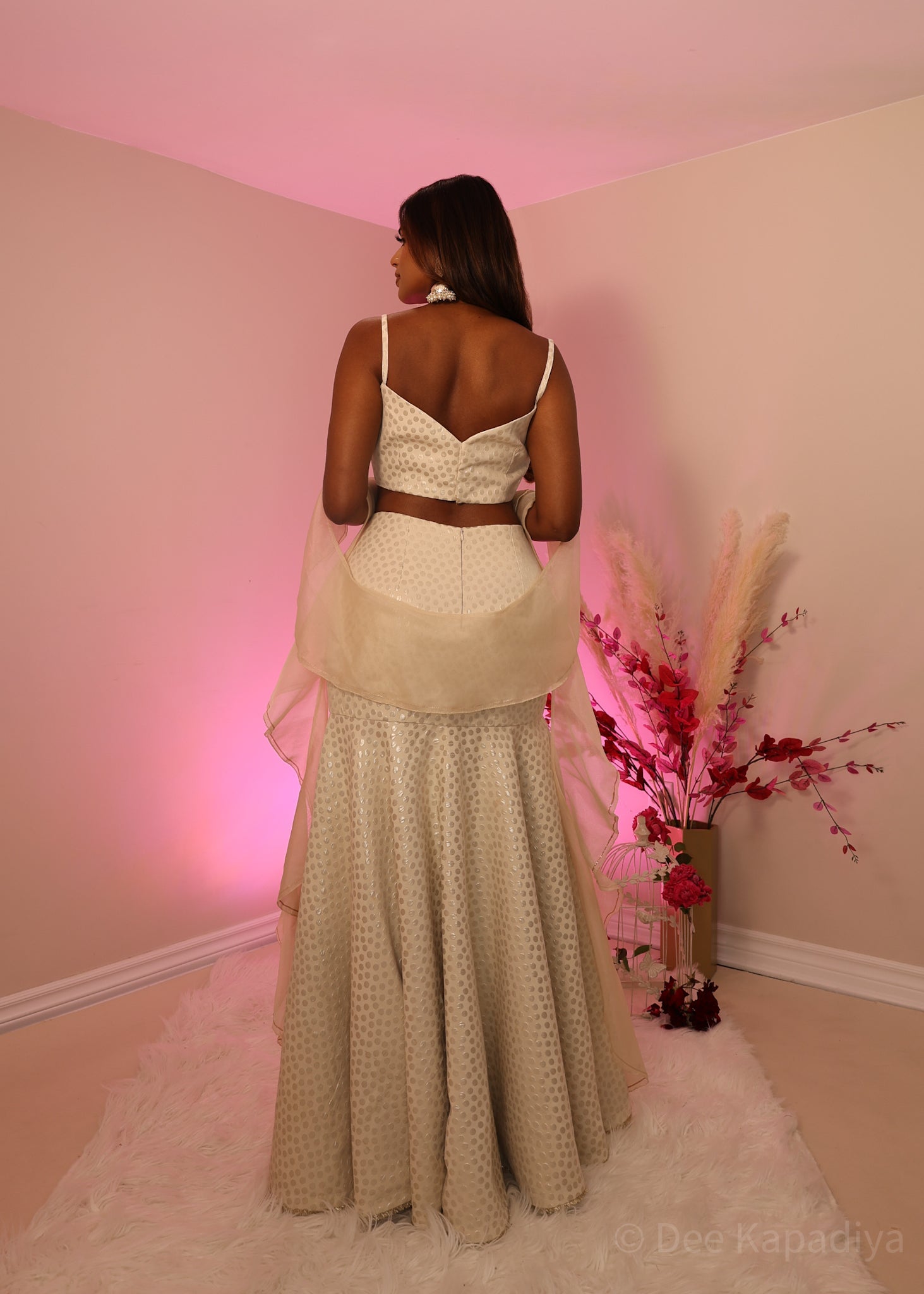 Ecru colour organza croptop with bronze embellishments, paired with champagne coloured polka dot mermaid style lehenga and organza ruffle shawl dupatta, perfect for bridal shower, wedding guest outfit or pre-wedding events 