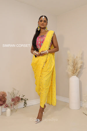 Ananya giving you all the yellow vibes in this gorgeous silky dhoti saree with hot pink printed corset for haldi or fiesta event