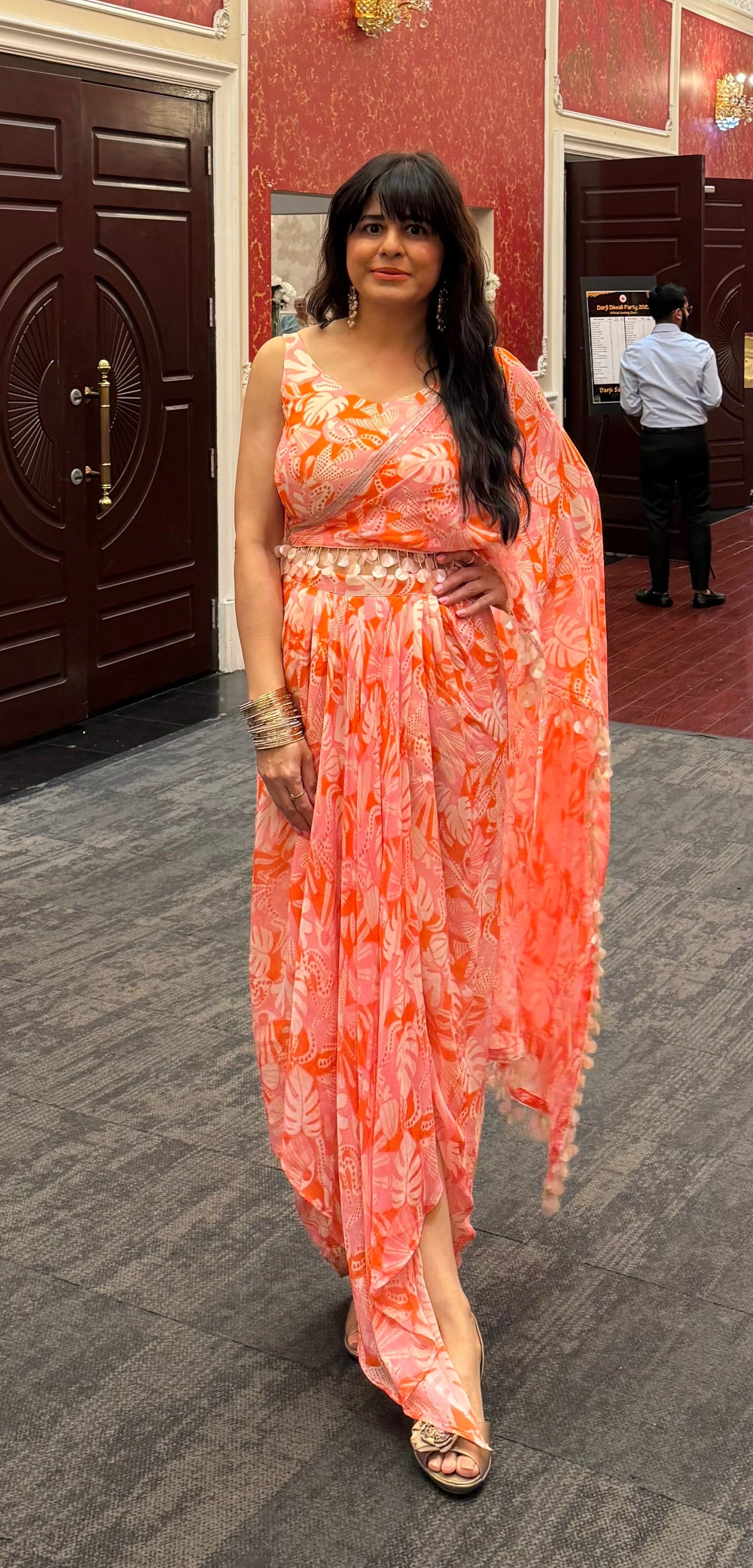 Like Meghna from Fashion statement dhoti saree drape in peach fuzz and pink colour fun print, perfect for mehendi, beach and welcome dinner