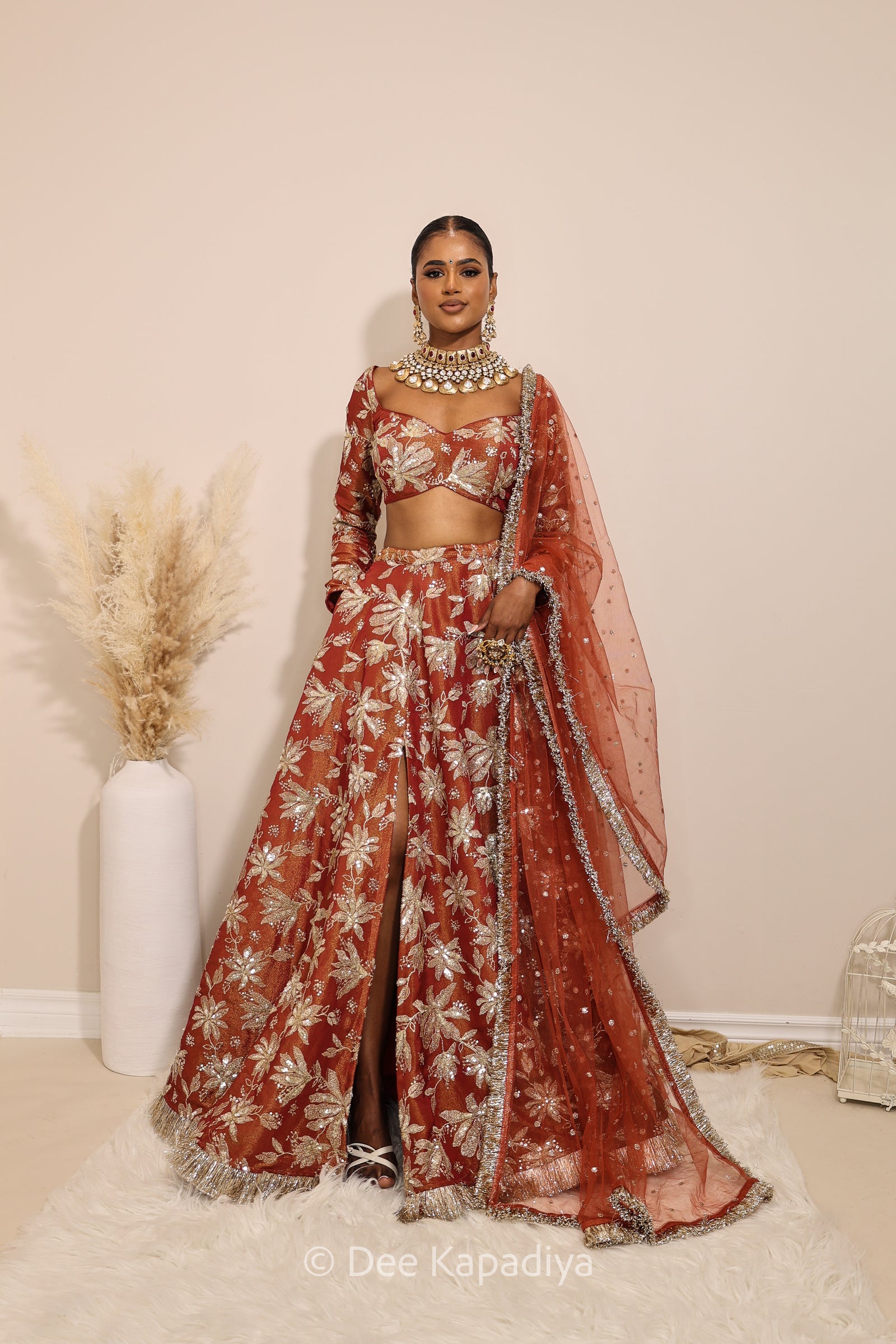 Lakshmi with jodha full circle lehenga  front in sunkissed rust for haldi, mehendi jaggo, wedding red women wearing lehenga with dupatta in traditional attire for pre-wedding event  