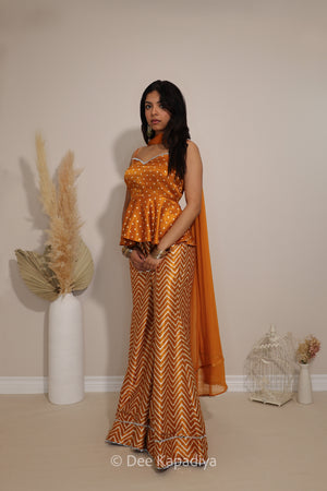Side view of Dee Kapadiya Nakhra Gharara Set in Haldi showing the peplum silhouette, chevron pants and chiffon dupatta