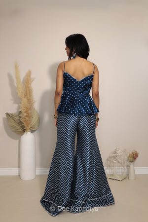 Back view of Dee Kapadiya Nakhra Gharara Set in Indigo showing the strappy peplum top and flared chevron pants