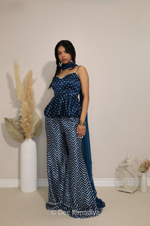 Model wearing Dee Kapadiya Nakhra Gharara Set in Indigo with mirror-work peplum top, chevron pants and chiffon dupatta