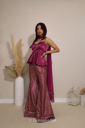 Model wearing Dee Kapadiya Nakhra Gharara Set in Masala with mirror-work peplum top, chevron pants and chiffon dupatta