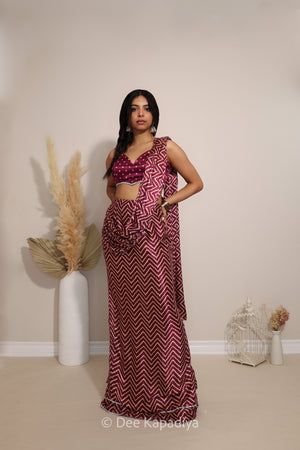 Model wearing Dee Kapadiya Pataka pre-draped Saree Set in Masala with Bandhani-print Phool crop top and chevron draped saree
