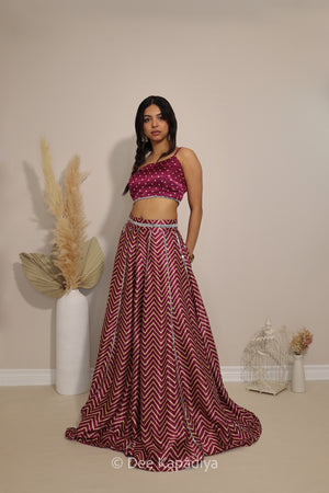 Side view of Dee Kapadiya Tamasha Lehenga Set in Masala showing the bandhani print Pataka crop top, chevron lehenga and chiffon dupatta